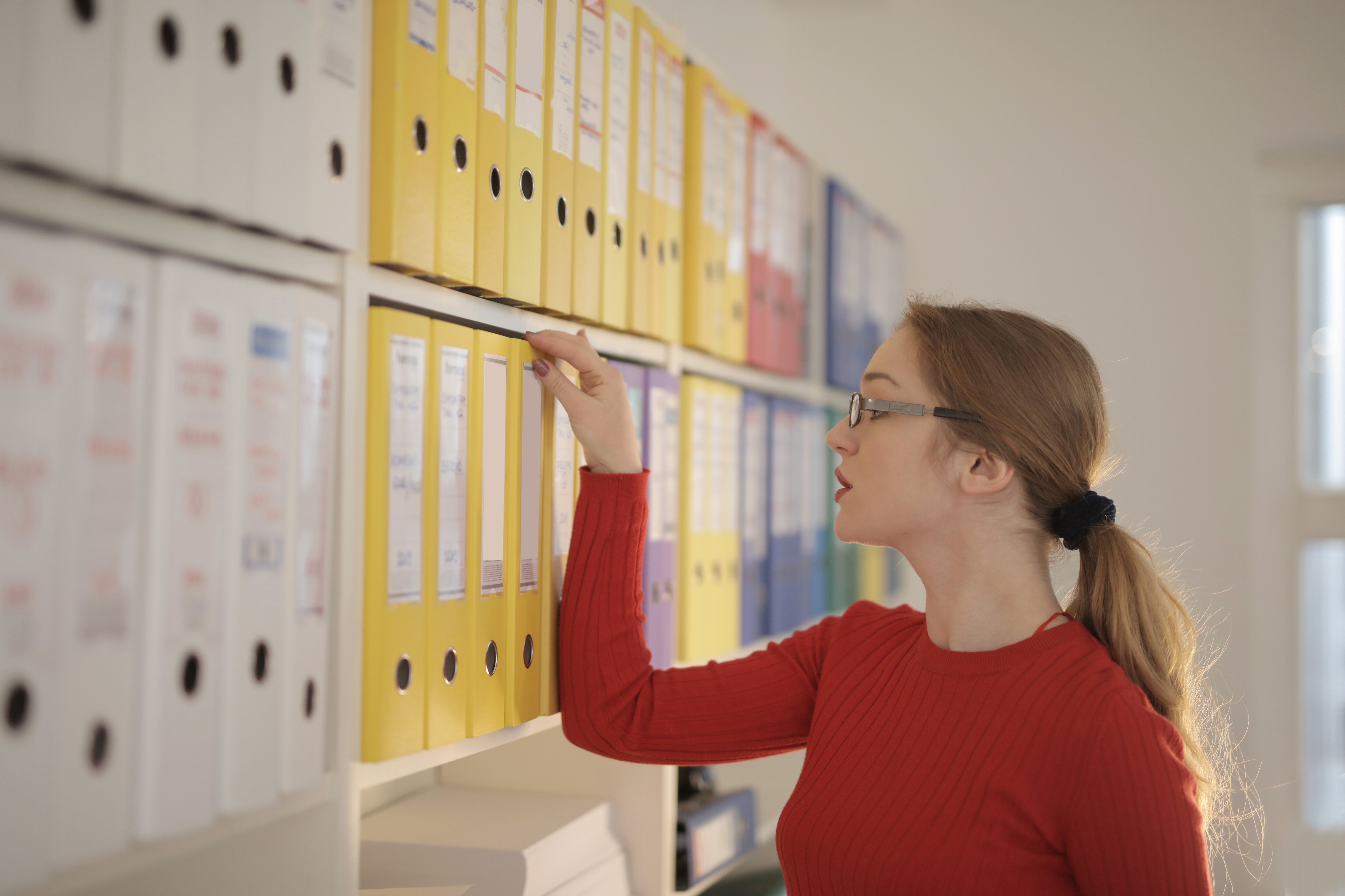 woman-looking-at-folders-3791159 woman-looking-at-folders-3791159